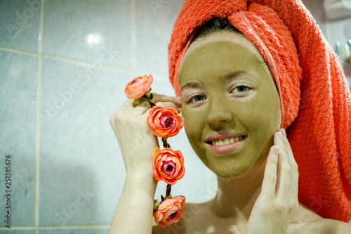 Fototapeta Naklejka Na Ścianę i Meble -  clay mask on the face of a young girl