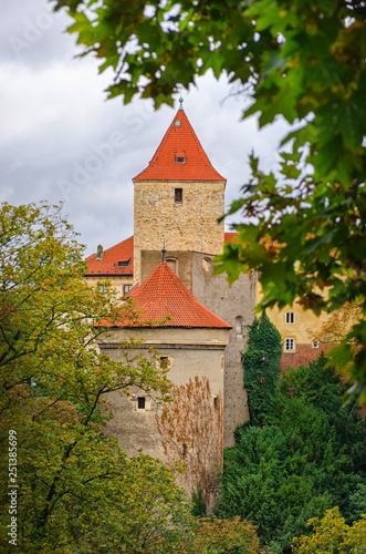 Red towers and wall of famous Hradcany castle. Prague, Czech Republic. Gloomy autumn weather