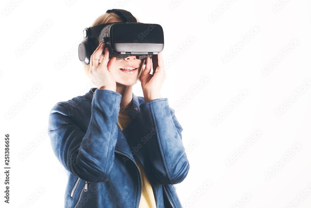 A young woman is wearing virtual reality glasses and reaching for something with his hands A young woman is wearing virtual reality glasses and reaching for something with his hands