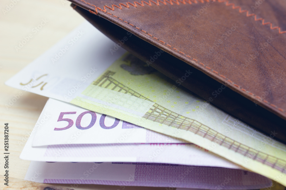 brown wallet with money .