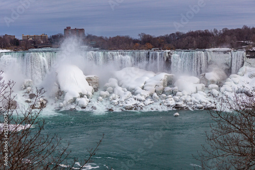 Wallpaper Mural Niagara Falls CANADA - February 23, 2019: Winter frozen view at the American side of beautiful Niagara Falls cower with snow and ice Torontodigital.ca