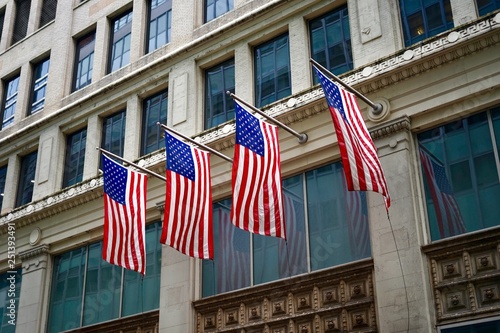 Four USA Flags Proudly Hanging from the Building Facade