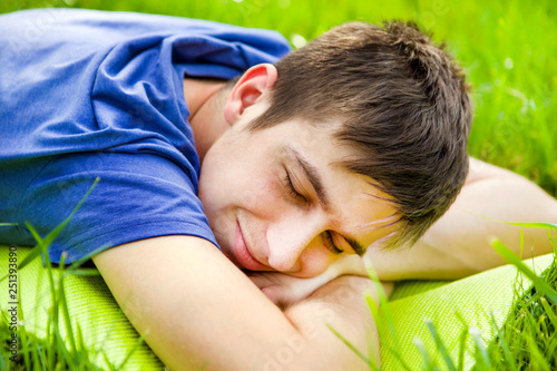 Billede på lærred Young Man rest on the Grass