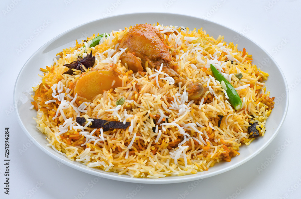 Chicken Biryani, A famous Indian Sub-continent savory rice dish mixed with spicy marinated chicken, spices and flavorful saffron. Chicken Biryani, A famous Indian Sub-continent savory rice dish mixed with spicy marinated chicken, spices and flavorful saffron.