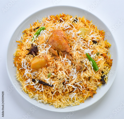 Chicken Biryani, A famous Indian Sub-continent savory rice dish mixed with spicy marinated chicken, spices and flavorful saffron. photo