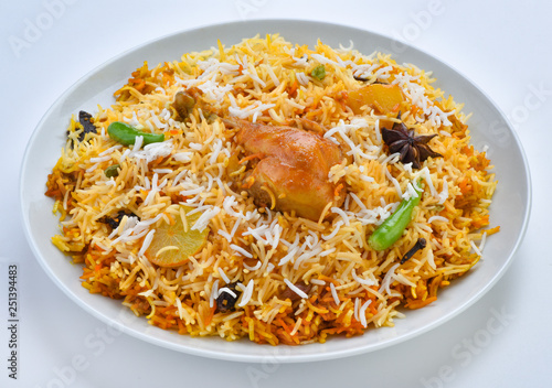 Chicken Biryani, A famous Indian Sub-continent savory rice dish mixed with spicy marinated chicken, spices and flavorful saffron.