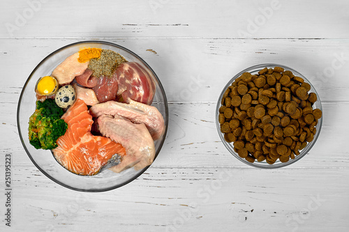 Fotografija Natural raw dog food BARF diet as opposite of kibble dry food Concept Closeup