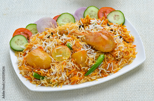 Chicken Biryani, A famous Indian Sub-continent savory rice dish mixed with spicy marinated chicken, spices and flavorful saffron. photo