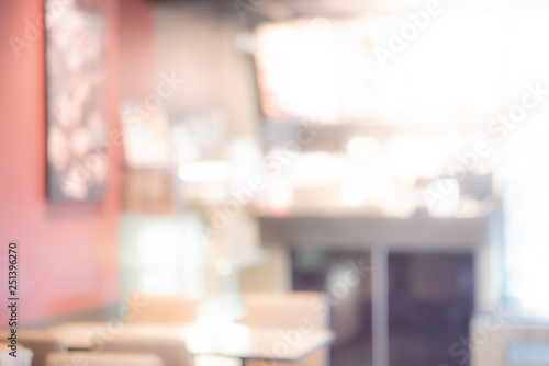 Abstract blurred restaurant background. Blurry cafe or coffee shop with dining tables, chairs and other decorations. Blur backdrop for design element. Food and beverage concept.