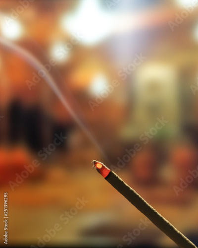 Burning Incense Sticks with smoke, joss sticks burning at a vintage Buddhist temple © Anthony Paz