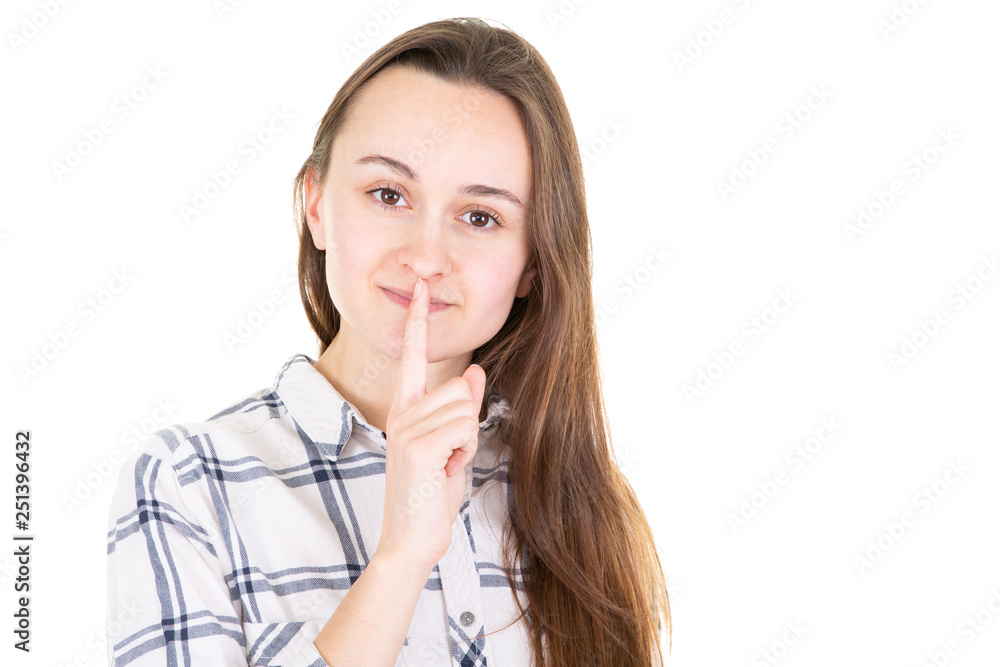 Closeup of a beautiful young woman with finger on her lips on a white background in Concept for silence Closeup of a beautiful young woman with finger on her lips on a white background in Concept for silence