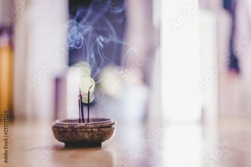 Smoking and smelling joss sticks at home, feng shui; Copy space photo
