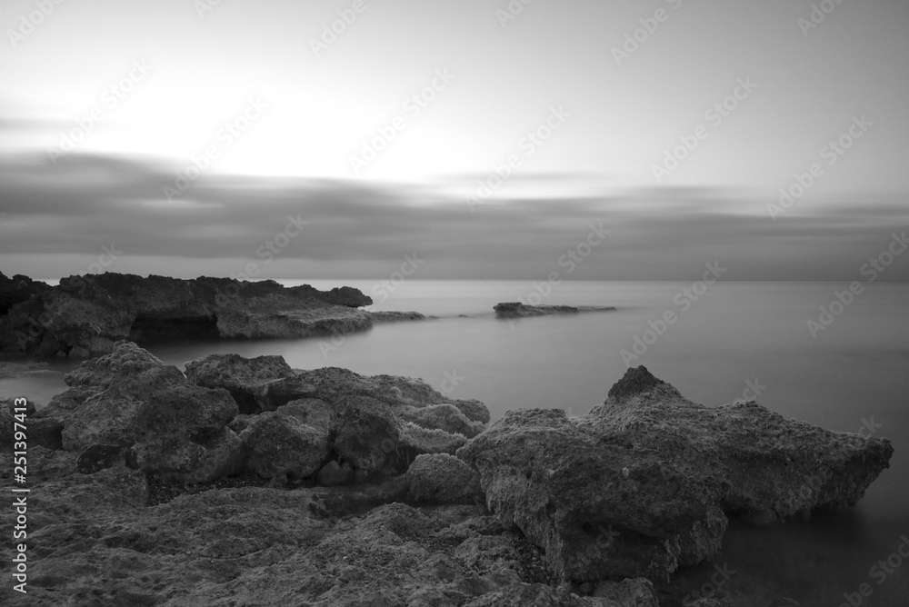 A sunrise by the sea in black and white