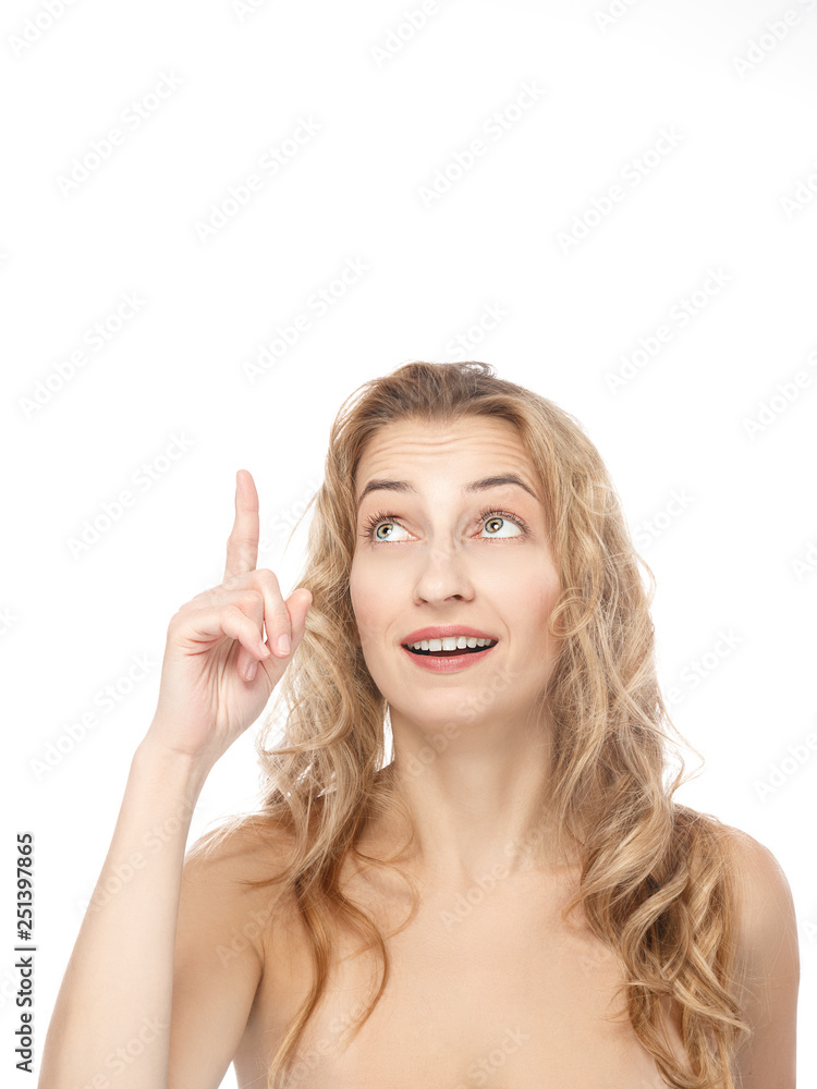 Beautiful, sexy, young woman points up, shows free space for your advertising content. The concept of emotions