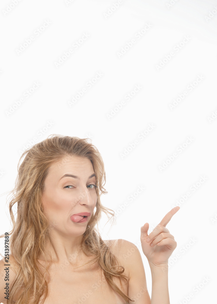 Beautiful, sexy, young woman points at the top right, funny facial expression, shows free space for your advertising content. The concept of emotions Beautiful, sexy, young woman points at the top right, funny facial expression, shows free space for your advertising content. The concept of emotions