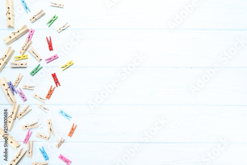 Colorful clothespins on wooden table