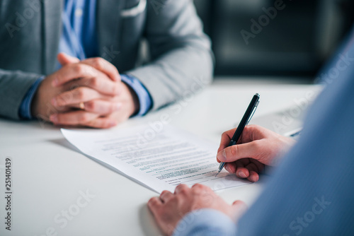 Signing contract on a meeting, close-up. photo