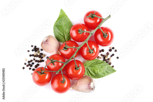 Cherry tomatoes with basil leafs, garlic and pepper isolated on white background