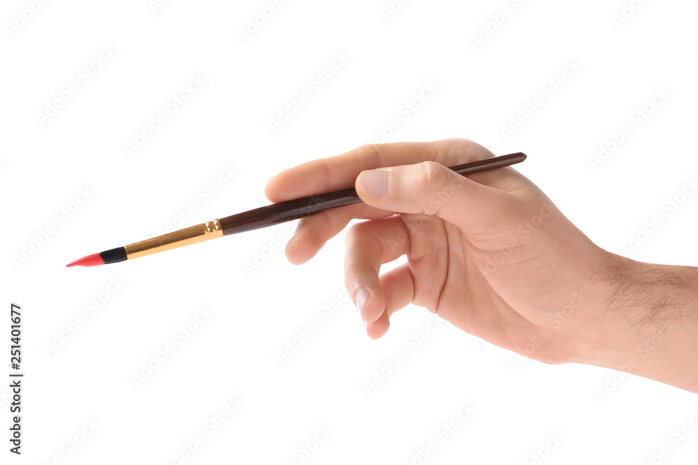 Young man holding brush with color paint on white background, closeup Young man holding brush with color paint on white background, closeup