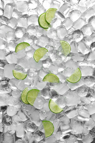 Flat lay composition with fresh lime slices on ice cubes