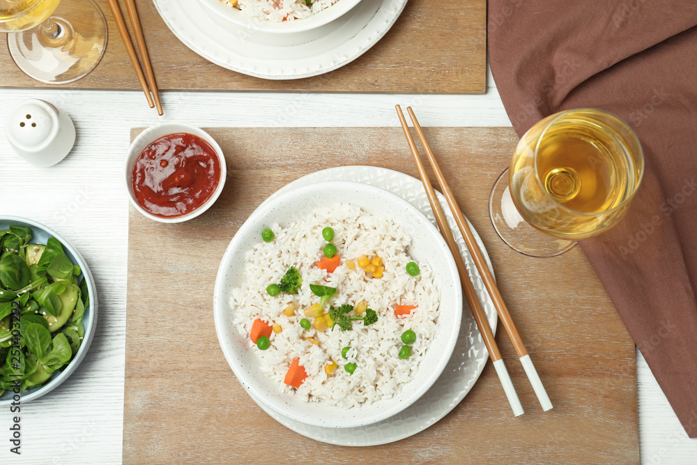 Boiled rice with vegetables served on table, flat lay Boiled rice with vegetables served on table, flat lay