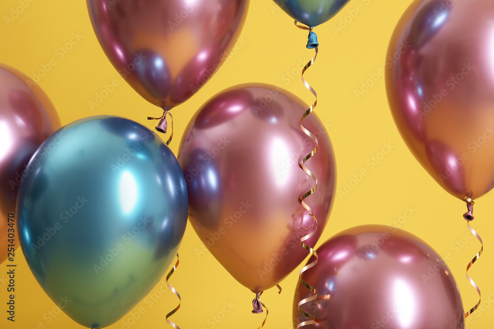 Bright balloons with ribbons on color background Bright balloons with ribbons on color background
