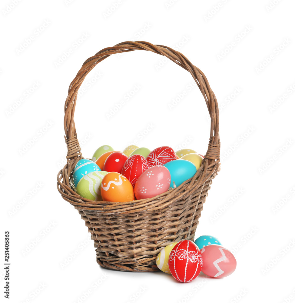 Wicker basket with painted Easter eggs on white background Wicker basket with painted Easter eggs on white background