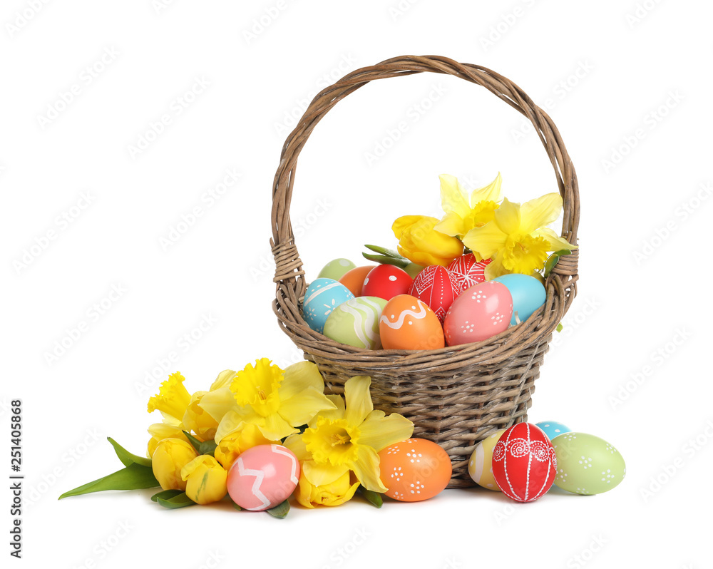 Wicker basket with painted Easter eggs and flowers on white background Wicker basket with painted Easter eggs and flowers on white background