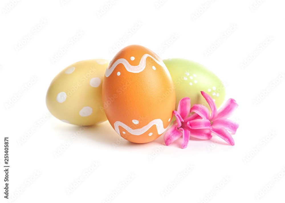 Colorful painted Easter eggs and flowers on white background