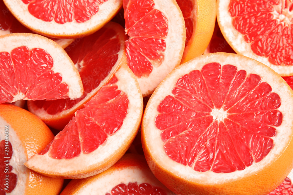 Many sliced fresh ripe grapefruits as background, closeup Many sliced fresh ripe grapefruits as background, closeup