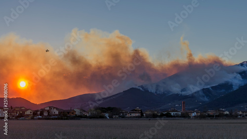Dramatic sunset on Bientina with Mount Pisano in flames in the background, Tuscany, Italy