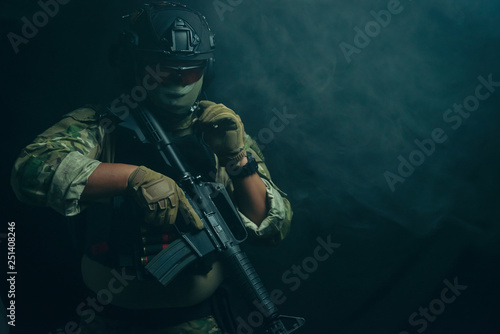 Spec ops police officer in black uniform on a studio background