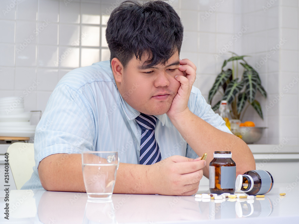 Asian fat man are taking medicines and vitamins for help Sick and healthy. Asian fat man are taking medicines and vitamins for help Sick and healthy.