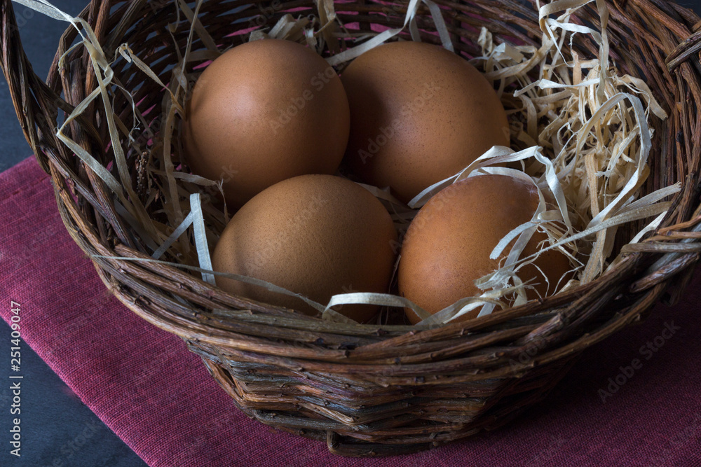 Easter basket with eggs, shot on a dark background Easter basket with eggs, shot on a dark background