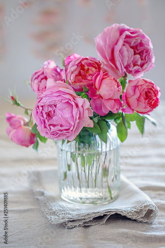 Delicate beautiful pink roses from a garden in a glass vase. English Roses,Variety - Princess Alexandra of Kent.