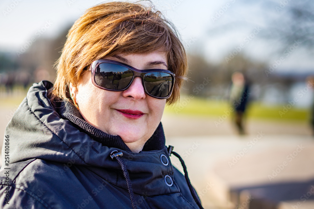Middle-aged woman in sunglasses Middle-aged woman in sunglasses