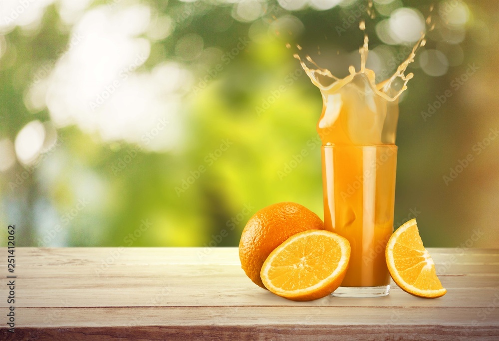 Naklejka premium Orange Juice in glass on background.