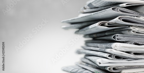 Pile of newspapers on white background photo