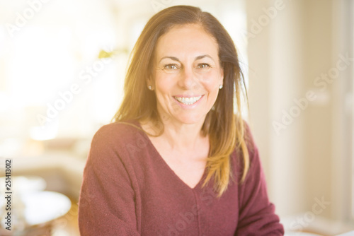 Beautiful middle age woman smiling at home
