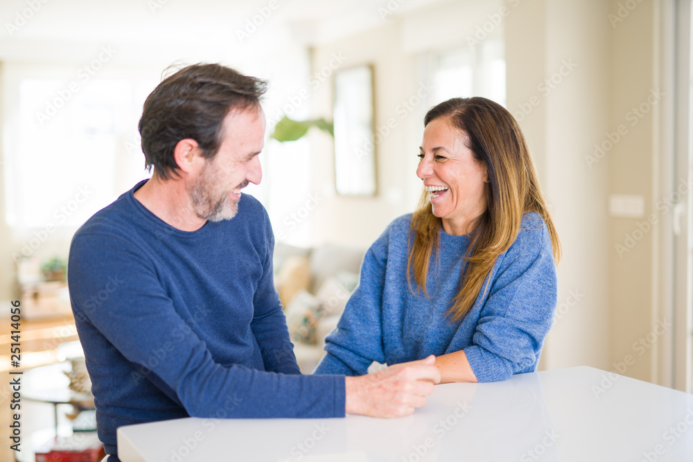 Romantic middle age couple sitting together at home