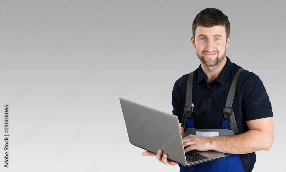 Portrait of cheerful Handsome mechanic on background Portrait of cheerful Handsome mechanic on background