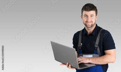 Portrait of cheerful Handsome  mechanic  on background