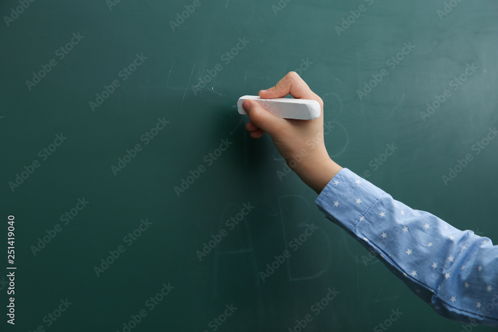 Little child writing on chalkboard, closeup. Space for text Little child writing on chalkboard, closeup. Space for text