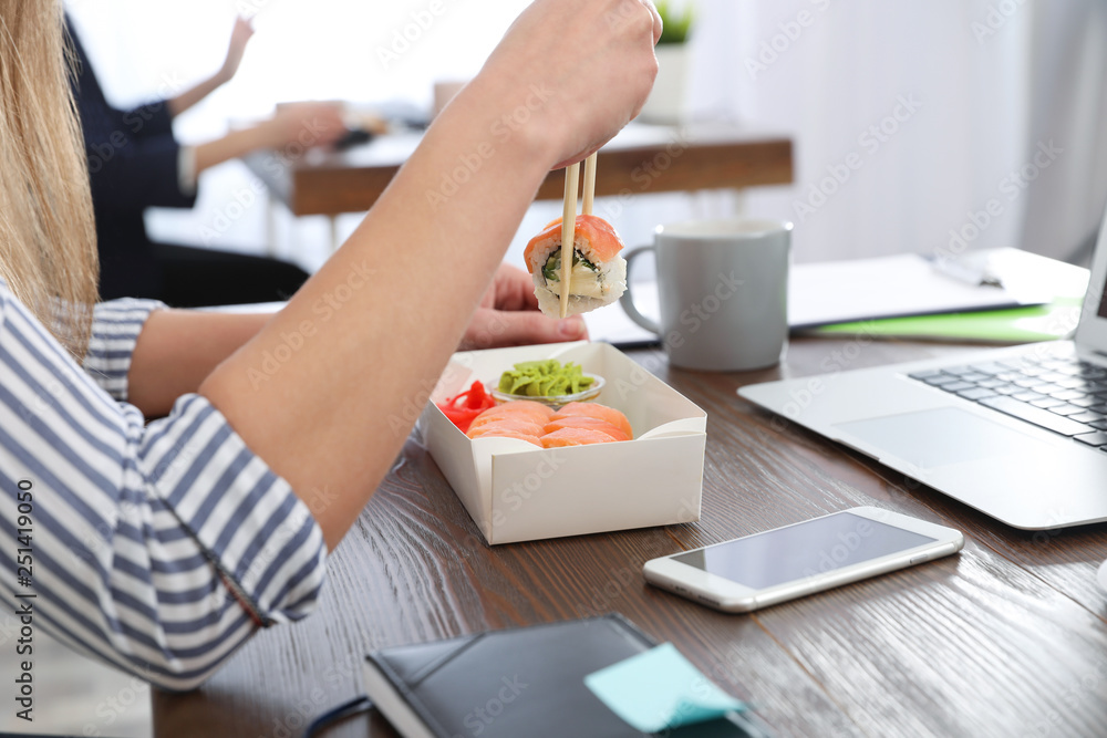 Office employee having lunch at workplace, closeup. Food delivery Office employee having lunch at workplace, closeup. Food delivery