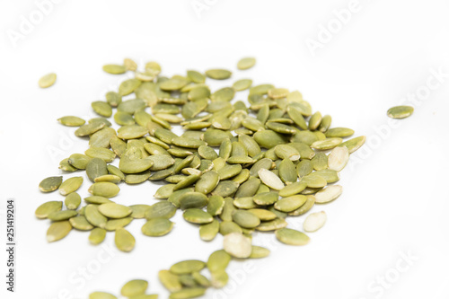Green pumpkin seed isolated on white background.