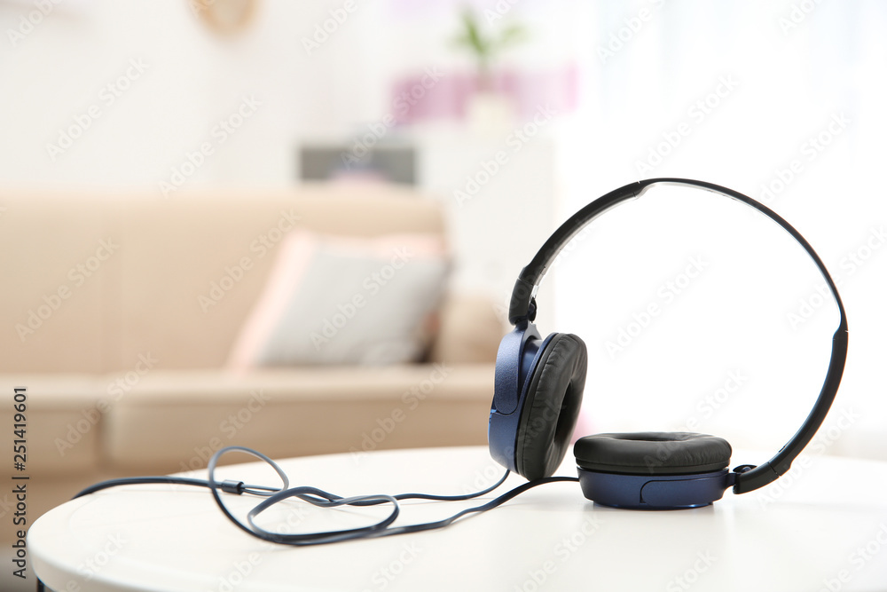 Stylish headphones on table indoors. Space for text Stylish headphones on table indoors. Space for text