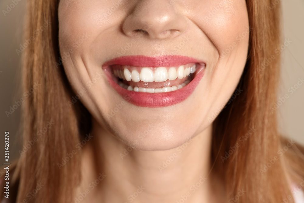 Smiling woman with perfect teeth on color background, closeup Smiling woman with perfect teeth on color background, closeup