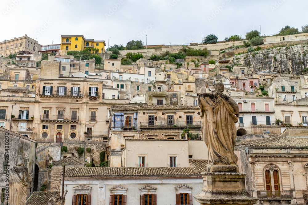 Stone statue outside the Duomo of Saint Peter san pietro in baroque town Modica, Sicily