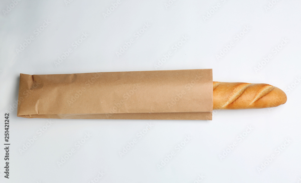 Paper bag with baguette on white background, top view. Space for design Paper bag with baguette on white background, top view. Space for design