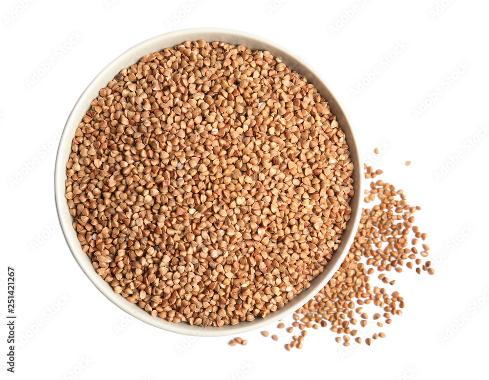 Bowl with uncooked buckwheat on white background, top view Bowl with uncooked buckwheat on white background, top view